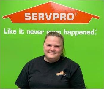 Female Servpro employee and Servpro logo
