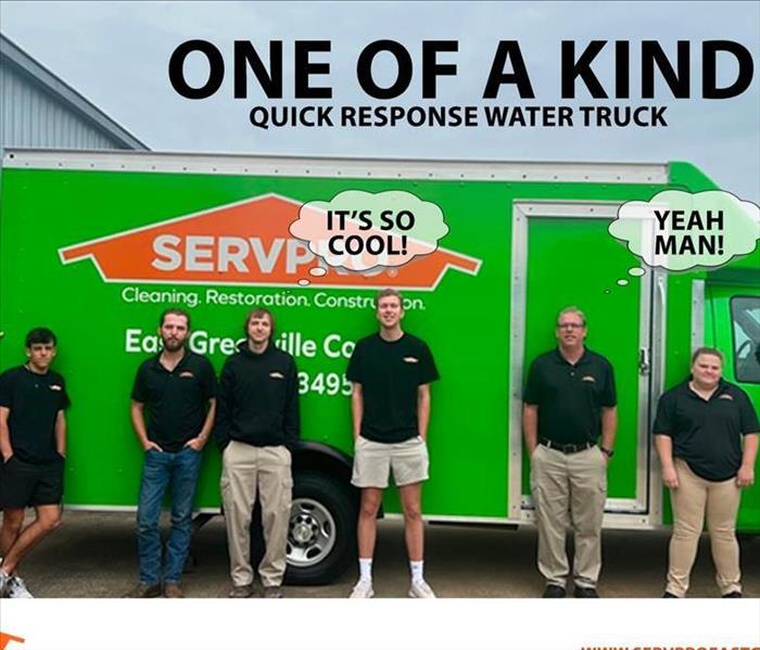 Employees standing in front of our new truck.